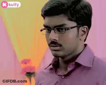 The Man Is Wearing Glasses And A Purple Shirt . GIF