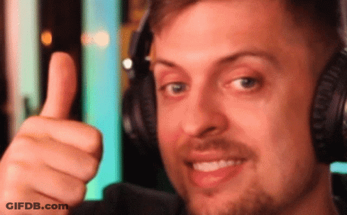 The Man Is Wearing Headphones And Giving A Thumbs Up GIF