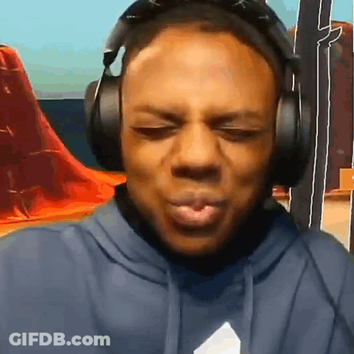 The Man Is Wearing Headphones And Making A Funny Face . GIF