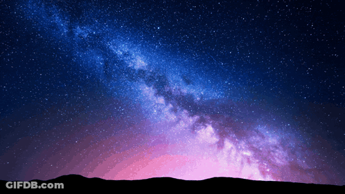 The Milky Way Galaxy Is Visible In The Night Sky Above A Mountain Range GIF