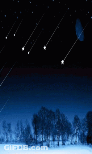 The Moon Is Visible In The Night Sky Above A Snowy Landscape GIF