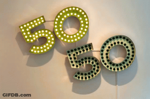 The Numbers 50 And 50 Are Displayed On A White Wall GIF
