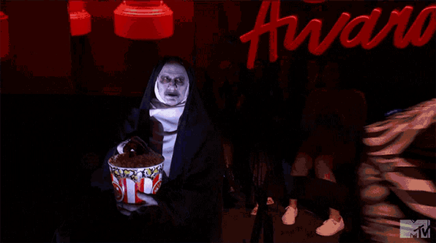 The Nun Eating Popcorn GIF