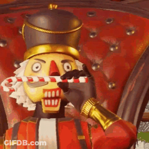 The Nutcracker Is Holding A Candy Cane In His Mouth . GIF
