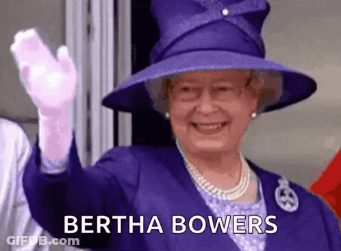 The Queen Is Wearing A Purple Hat And Gloves And Waving At The Camera . GIF