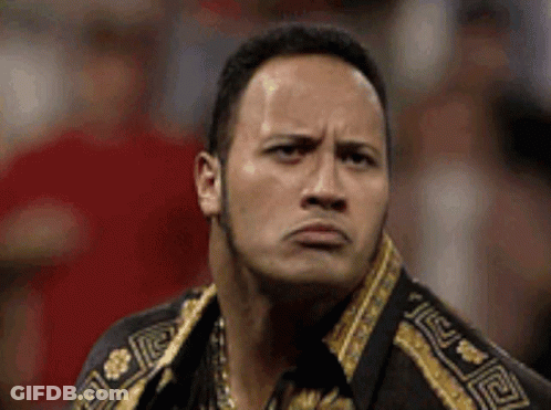The Rock Is Making A Funny Face While Wearing A Gold And Black Jacket . GIF