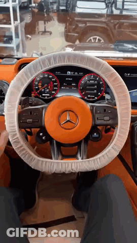 The Steering Wheel Of A Mercedes Is Covered With Plastic GIF