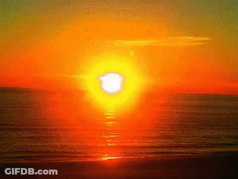 The Sun Is Setting Over The Ocean GIF