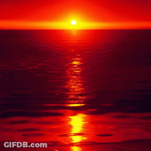 The Sun Is Setting Over The Ocean And The Water Is Red GIF