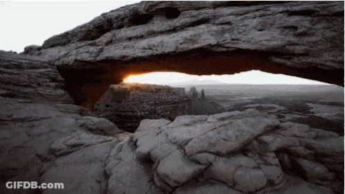 The Sun Is Shining Through A Rock Arch GIF