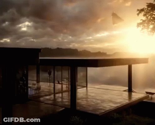 The Sun Is Shining Through The Clouds Behind A House GIF