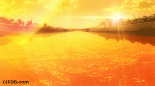 The Sun Shines Brightly Over A River With Buildings In The Background GIF
