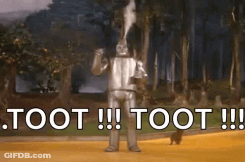 The Tin Man From The Wizard Of Oz Is Blowing Smoke Out Of His Mouth And Says Toot ! GIF