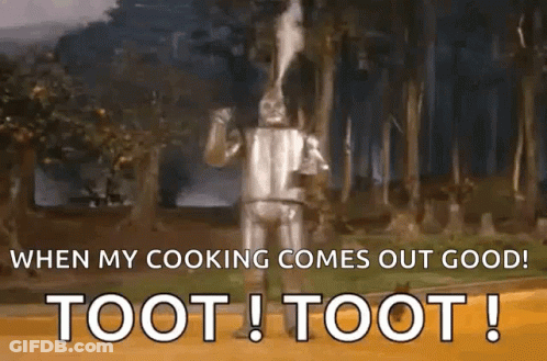 The Tin Man From The Wizard Of Oz Is Standing In The Woods And Smoking A Pipe . GIF