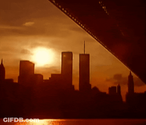 The Twin Towers Are Silhouetted Against A Sunset Skyline GIF