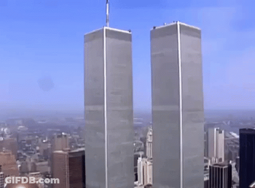 The Twin Towers Of The World Trade Center Are Visible In A Cityscape GIF