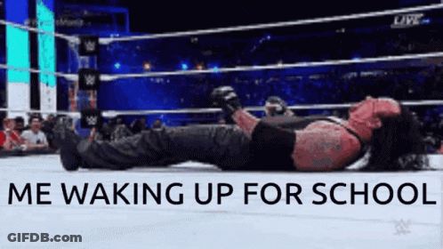 The Undertaker Is Laying On The Ground In A Wrestling Ring GIF