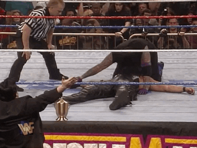 The Undertaker Putting Opponent's Hands GIF