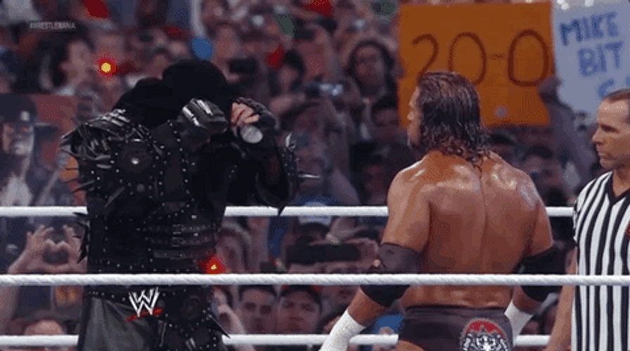 The Undertaker Removing His Bonnet GIF