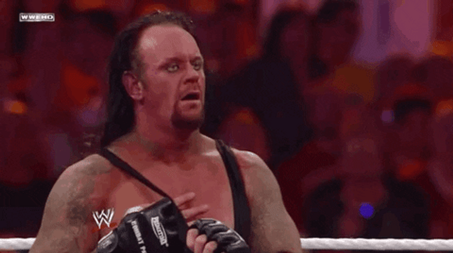 The Undertaker Removing His Shirt GIF