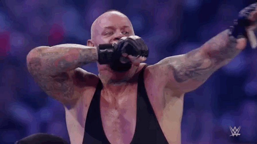 The Undertaker Stretching His Arms GIF