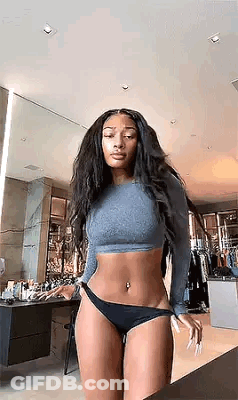 The Woman Is Wearing A Crop Top And Black Underwear . GIF