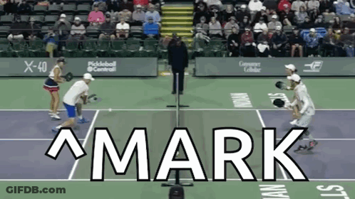 The Word Mark Is On A Tennis Court With People Playing GIF