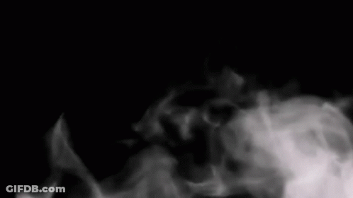 The Word Now Is Surrounded By Smoke In A Black Background GIF