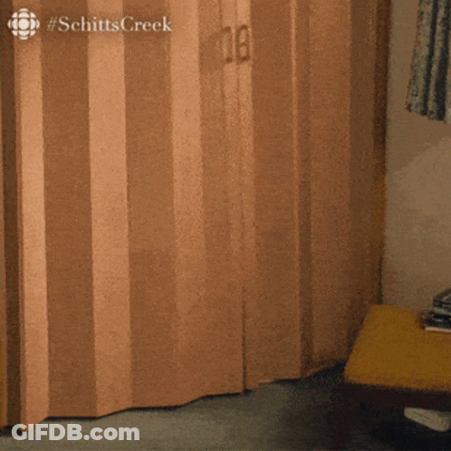 The Word Schitts Creek That Is On A Wooden Door GIF