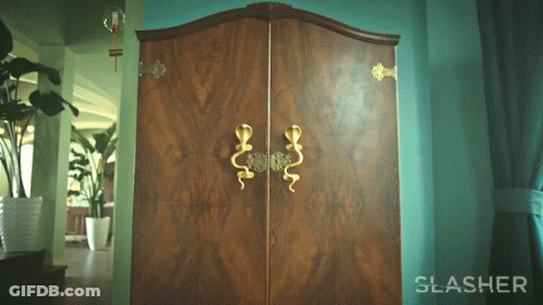 The Word Slasher Is On A Green Wall Next To A Wooden Cabinet GIF