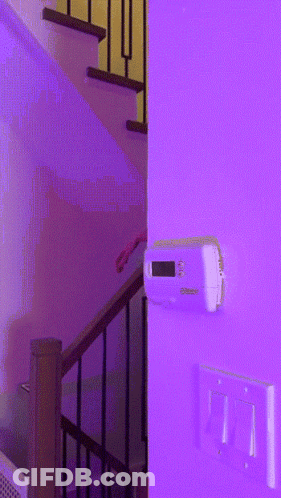 Thermostat On Purple Wall Next To Stairs GIF