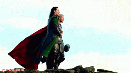 Thor And Loki Are Standing On Top Of A Rocky Hill With A Hammer In Their Hand GIF