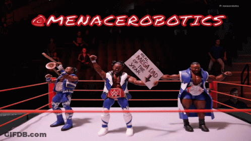 Three Action Figures In A Wrestling Ring With A Sign That Says Megadad Of The Year GIF