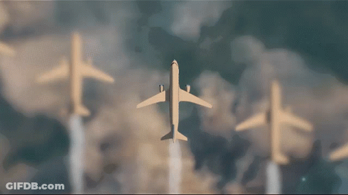 Three Airplanes Flying In A Row Against Blue Sky GIF