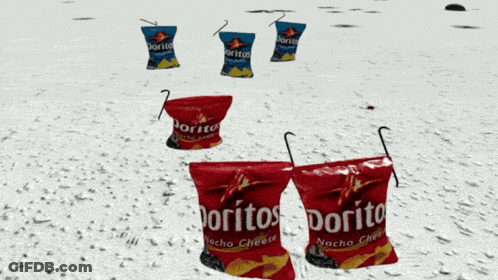 Three Bags Of Doritos Nacho Cheese Are Sitting On A Snowy Beach GIF