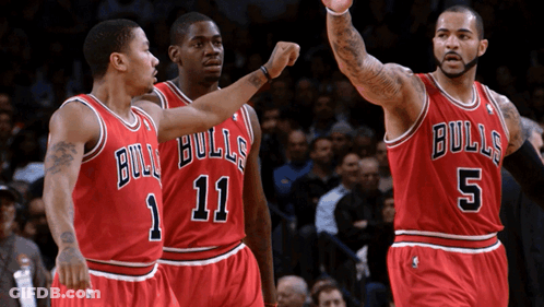 Three Basketball Players Wearing Bulls Uniforms Are Standing Together GIF