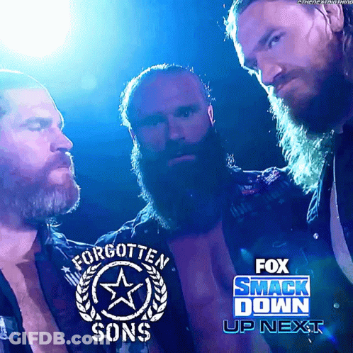 Three Bearded Men Are Standing Next To Each Other In Front Of A Fox Smack Down Sign GIF