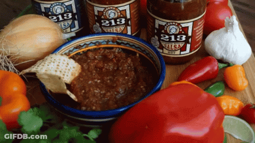 Three Bottles Of 213 Salsa Are On A Table With Vegetables GIF