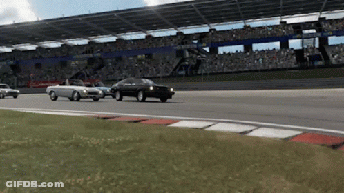 Three Cars Are Driving On A Race Track In Front Of A Crowd And A Sign That Says ' Hyundai ' On It GIF
