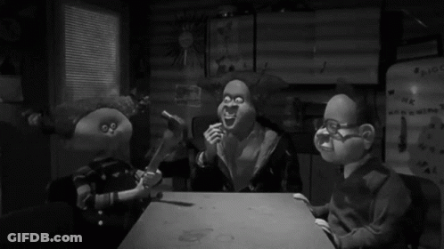 Three Cartoon Characters Are Sitting At A Table In Front Of A Refrigerator That Says ' Hk ' On It GIF