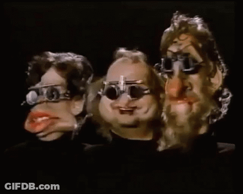 Three Cartoon Characters Wearing Glasses Are Standing Next To Each Other . GIF