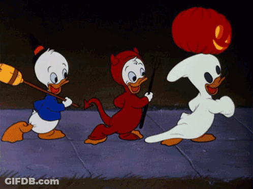 Three Cartoon Ducks Dressed In Halloween Costumes Are Walking Down A Sidewalk GIF