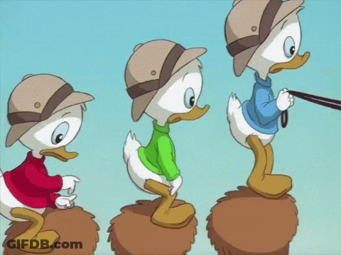 Three Cartoon Ducks In Hats And Sweaters On A Pile GIF