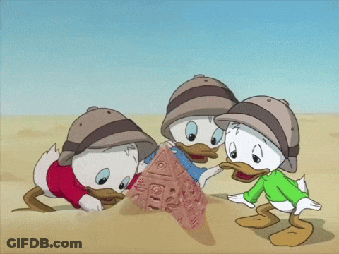 Three Cartoon Ducks Playing In Sand One In Green Shirt GIF