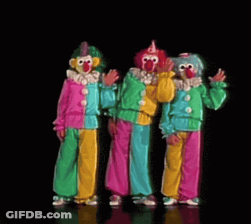 Three Clowns Are Standing Next To Each Other And Waving At The Camera GIF