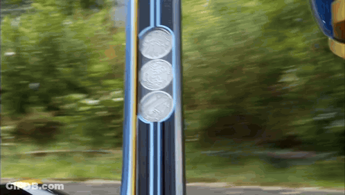 Three Coins On Pole Saying Coca Cola GIF