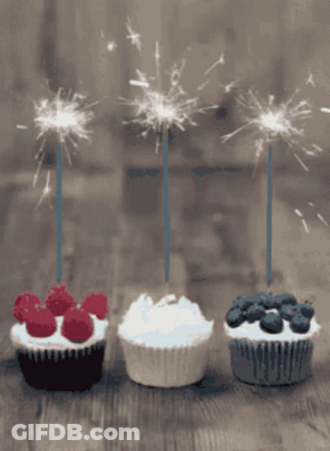 Three Cupcakes With Sparklers Lined Up GIF