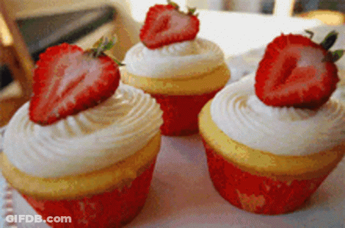 Three Cupcakes With Strawberries On Plate GIF