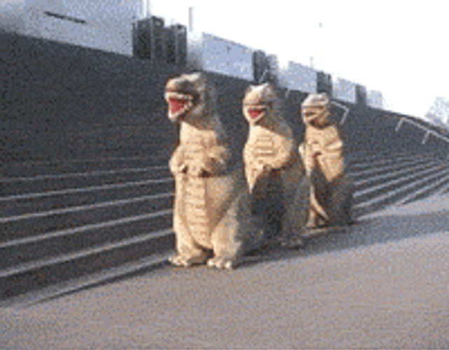 Three Dinosaur Mascots Dance Party GIF