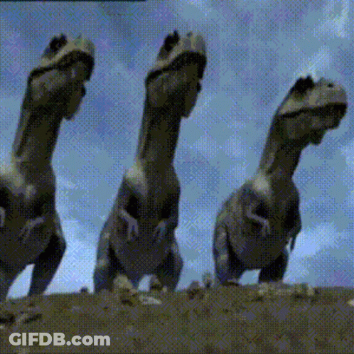 Three Dinosaurs Standing On Hill GIF